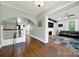 Elegant foyer with hardwood floors, staircase, and arched doorway to the living area at 407 Chesterfield Ave, Lancaster, SC 29720