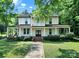 Beautiful two-story home with an inviting wrap-around porch and manicured lawn at 407 Chesterfield Ave, Lancaster, SC 29720
