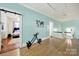 Light blue hallway with hardwood floors and access to multiple rooms at 407 Chesterfield Ave, Lancaster, SC 29720
