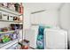 Functional laundry room with washer, dryer, shelving, and natural light at 407 Chesterfield Ave, Lancaster, SC 29720