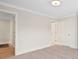 Large room with plush carpeting, crisp white walls, and abundant natural light, adjacent to hallway at 4412 Foxview Ct, Charlotte, NC 28270