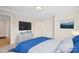 Bright bedroom with mounted TV and modern blue bedding, styled with neutral walls and minimal decor at 4412 Foxview Ct, Charlotte, NC 28270