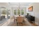Elegant dining room with modern light fixture, large windows, and hardwood floors at 4412 Foxview Ct, Charlotte, NC 28270