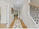 Inviting foyer with hardwood floors, wainscoting, staircase, and an open view to the living space at 4412 Foxview Ct, Charlotte, NC 28270