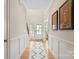 Bright hallway with a neutral color palette, hardwood floors, and wainscoting at 4412 Foxview Ct, Charlotte, NC 28270
