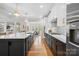 Modern kitchen featuring white cabinets, stainless steel appliances, large island and open layout at 4412 Foxview Ct, Charlotte, NC 28270