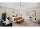 This beautiful main bedroom features neutral walls, a sitting area, and a tray ceiling with a modern ceiling fan at 4412 Foxview Ct, Charlotte, NC 28270