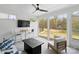 Bright sunroom features a cozy seating area, views of the backyard, and a ceiling fan at 4412 Foxview Ct, Charlotte, NC 28270