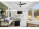 Relaxing sunroom featuring a comfortable seating area and a view of the landscaped backyard and a ceiling fan at 4412 Foxview Ct, Charlotte, NC 28270