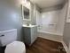 Bathroom featuring gray vanity, toilet, and tub/shower combination at 501 E Lafayette St, Salisbury, NC 28144