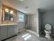 Bathroom with gray vanity, tiled shower, and toilet; stylish and functional at 501 E Lafayette St, Salisbury, NC 28144