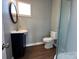 Small bathroom with walk-in shower, vanity, and dark vinyl floors at 501 E Lafayette St, Salisbury, NC 28144