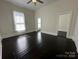 Bedroom featuring dark wood floors, high ceilings, and a ceiling fan at 501 E Lafayette St, Salisbury, NC 28144