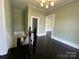 Upstairs hallway with hardwood floors, stairs, and white trim at 501 E Lafayette St, Salisbury, NC 28144