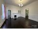Bright and spacious living room boasts hardwood floors and decorative fireplace at 501 E Lafayette St, Salisbury, NC 28144