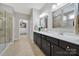 Well-lit bathroom with double vanity, walk-in shower, and access to the walk-in closet at 5039 Folly Ln, Fort Mill, SC 29707