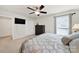 Bright primary bedroom featuring large windows, closet and ceiling fan at 5039 Folly Ln, Fort Mill, SC 29707