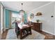 Inviting dining room featuring a wood table, elegant chandelier, and a stylish rug at 5039 Folly Ln, Fort Mill, SC 29707