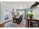 Bright dining room with a wooden table, woven chairs, and a view to the outdoor space at 5039 Folly Ln, Fort Mill, SC 29707