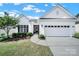 Charming single-story home with manicured lawn, mature landscaping, and attached two-car garage at 5039 Folly Ln, Fort Mill, SC 29707