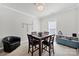 Cozy game room with a square table, accent chair, window, and a cabinet full of games at 5039 Folly Ln, Fort Mill, SC 29707