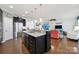 Open kitchen with a center island, dark cabinets, and stainless steel appliances, connecting to the living area at 5039 Folly Ln, Fort Mill, SC 29707
