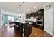 Modern kitchen features a large island with seating, dark cabinets, and stainless steel appliances at 5039 Folly Ln, Fort Mill, SC 29707