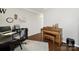Bright office features wood floors, custom paint, a large desk area and a decorative piano at 5039 Folly Ln, Fort Mill, SC 29707