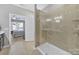 Modern walk-in shower with neutral tile and glass enclosure at 5039 Folly Ln, Fort Mill, SC 29707
