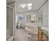 Bathroom featuring a large soaking tub, walk-in shower, and a window for natural light at 5110 Old Still Ln, Bessemer City, NC 28016