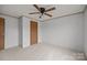 Carpeted bedroom features two closets, ceiling fan and neutral walls at 5110 Old Still Ln, Bessemer City, NC 28016