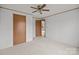 Neutral bedroom with carpet and ceiling fan showing access to closet and the adjacent room at 5110 Old Still Ln, Bessemer City, NC 28016