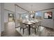 Inviting dining room with stylish chandelier and large windows, adjacent to the living area at 5110 Old Still Ln, Bessemer City, NC 28016