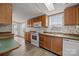 Functional kitchen with white appliances, wood cabinets, and a window above the sink area at 5110 Old Still Ln, Bessemer City, NC 28016