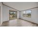 Bright room with wood-look flooring and sliding glass doors leading to a deck and two windows for natural light at 5110 Old Still Ln, Bessemer City, NC 28016