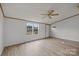 Bright living room features wood-look flooring and a ceiling fan, plus natural light from double windows at 5110 Old Still Ln, Bessemer City, NC 28016