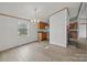 Open living room leading to kitchen showcases modern floors, chandelier, and a cozy fireplace at 5110 Old Still Ln, Bessemer City, NC 28016