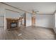 Spacious living room featuring a brick fireplace and modern flooring, adjacent to the kitchen at 5110 Old Still Ln, Bessemer City, NC 28016