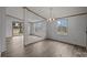 Bright living room boasts wood-look floors, neutral paint and an open floorplan with a view of the back deck at 5110 Old Still Ln, Bessemer City, NC 28016
