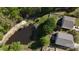 Aerial view of the property showcases the home's location near a pond with lush greenery and trees at 517 Bertram Rd, Fort Mill, SC 29708