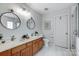 Bright bathroom featuring a double vanity, updated fixtures, and glass shower with white tile at 517 Bertram Rd, Fort Mill, SC 29708