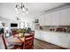 Dining room features wood table with chairs, pendant lighting and kitchen with gray backsplash at 517 Bertram Rd, Fort Mill, SC 29708