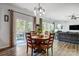 Dining room features wood table with chairs, pendant lighting and sliding glass doors to back patio at 517 Bertram Rd, Fort Mill, SC 29708