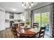 Dining room features wood table with chairs, pendant lighting and open concept kitchen at 517 Bertram Rd, Fort Mill, SC 29708