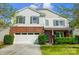 Charming two-story home with a brick and vinyl exterior, attached garage, and well-maintained lawn at 517 Bertram Rd, Fort Mill, SC 29708
