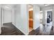 Hallway view showcasing hardwood floors, white molding, and a bathroom with a wooden vanity at 517 Bertram Rd, Fort Mill, SC 29708