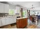 Open concept kitchen featuring white cabinets, dining room, and sliding glass doors to back patio at 517 Bertram Rd, Fort Mill, SC 29708
