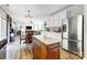 Open concept kitchen featuring stainless steel appliances, island, dining room, and living room at 517 Bertram Rd, Fort Mill, SC 29708