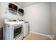 Functional laundry room with modern washer and dryer and overhead storage at 517 Bertram Rd, Fort Mill, SC 29708