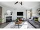 Comfortable living room features a fireplace, ceiling fan, television, and cozy seating area at 517 Bertram Rd, Fort Mill, SC 29708
